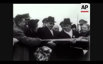 In this screenshot, Chaim Weizmann cuts a tape to symbolize his official entrance into Jerusalem for his inauguration as president (Photo courtesy AP) In this screenshot, Chaim Weizmann cuts a tape to symbolize his official entrance into Jerusalem for his inauguration as president (Photo courtesy AP)
