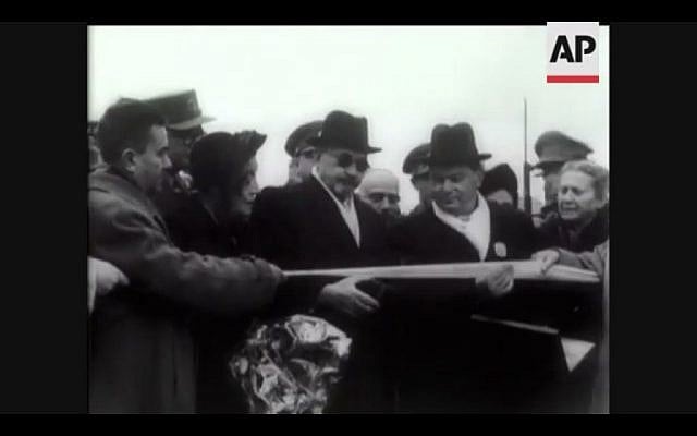 In this screenshot, Chaim Weizmann cuts a tape to symbolize his official entrance into Jerusalem for his inauguration as president (Photo courtesy AP) In this screenshot, Chaim Weizmann cuts a tape to symbolize his official entrance into Jerusalem for his inauguration as president (Photo courtesy AP)