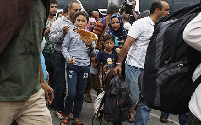A migrant boy eats bread upon arrival at the Westbahnhof railroadstation in Vienna, on September 5, 2015 as hundreds of migrants arrive by bus and train from Hungary to continue their journey to Germany. (AFP PHOTO/DIETER NAGL) A migrant boy eats bread upon arrival at the Westbahnhof railroadstation in Vienna, on September 5, 2015 as hundreds of migrants arrive by bus and train from Hungary to continue their journey to Germany. (AFP PHOTO/DIETER NAGL)