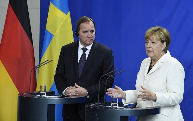 German Chancellor Angela Merkel, right, and Swedish Prime Minister Stefan Loefven arrive for a press conference after talks in Berlin September 8, 2015. (AFP/TOBIAS SCHWARZ)