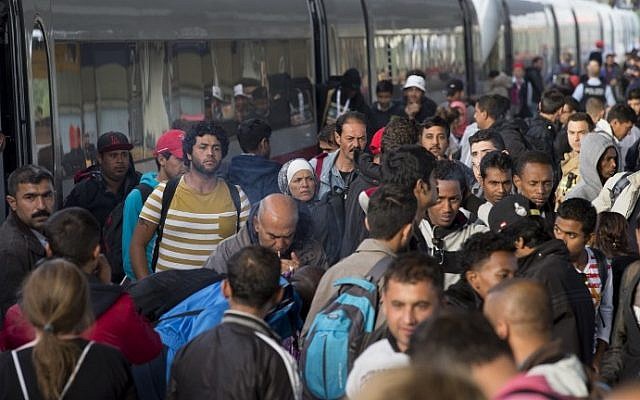 Refugees get out of a special train coming from Munich upon arrival at the railway station in Berlin Schoenefeld on September 13, 2015. (Axel Schmidt/AFP) Refugees get out of a special train coming from Munich upon arrival at the railway station in Berlin Schoenefeld on September 13, 2015. (Axel Schmidt/AFP)