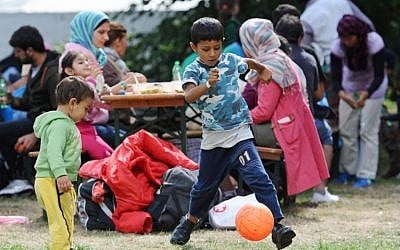 Migrant children play at a temporary camp for asylum-seekers near the main railway station in Munich, southern Germany, on September 13, 2015. (Andreas Gebert/DPA/AFP)