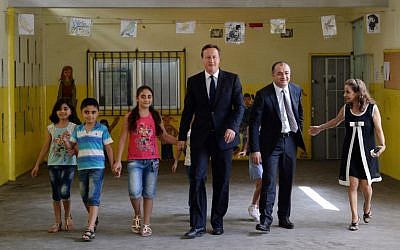 Britain's Prime Minister David Cameron (C) and Lebanese Education Minister Elias Bou Saab (2R) visit the Sed El Bouchrieh School in Beirut on September 14, 2015. (AFP PHOTO/POOL/STEFAN ROUSSEAU)