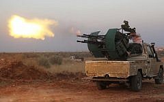 Rebel fighters fire a heavy machine gun during clashes with Syrian pro-government forces on the front facing Deir al-Zoghb, a government-held area in the northwestern Idlib province, on August 31, 2015. (AFP Photo/Omar Haj Kadour)