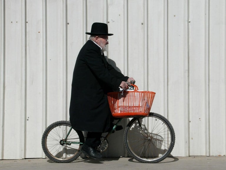 A picture dated on February 5, 2002 shows an ultra-Orthodox Jewish man riding his bicycle with his shopping basket hanging on the handles as he makes his way to the outdoors market in Jerusalem. (AFP/Gabriel BOUYS) A picture dated on February 5, 2002 shows an ultra-Orthodox Jewish man riding his bicycle with his shopping basket hanging on the handles as he makes his way to the outdoors market in Jerusalem. (AFP/Gabriel BOUYS)
