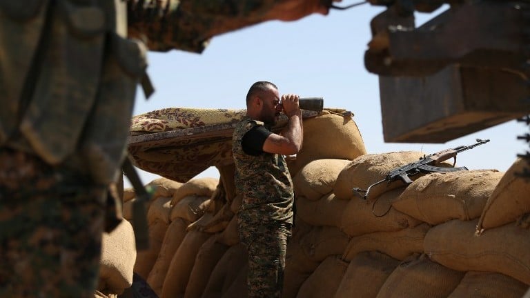 File: A fighter from the Kurdish People Protection Unit (YPG) uses binoculars on the front line in the northeastern Syrian city of Hasakeh on September 4, 2015. (Delil Souleiman/AFP) File: A fighter from the Kurdish People Protection Unit (YPG) uses binoculars on the front line in the northeastern Syrian city of Hasakeh on September 4, 2015. (Delil Souleiman/AFP)