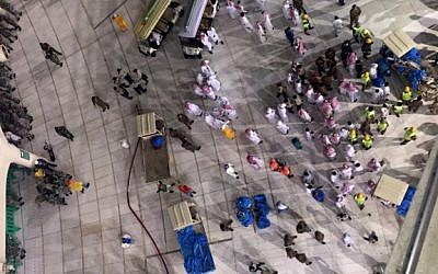 Saudi emergency teams gather inside the Grand Mosque of Saudi Arabia's holy Muslim city of Mecca after a construction crane crashed into it on September 11, 2015, killing dozens of people. (AFP PHOTO/STR)