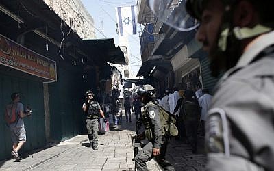 Police use stun grenades to disperse Palestinian demonstrators in a street of the Muslim quarter in Jerusalem's Old City during scuffles with Israeli riot police on the Temple Mount on September 15, 2015. (AFP PHOTO/ THOMAS COEX)