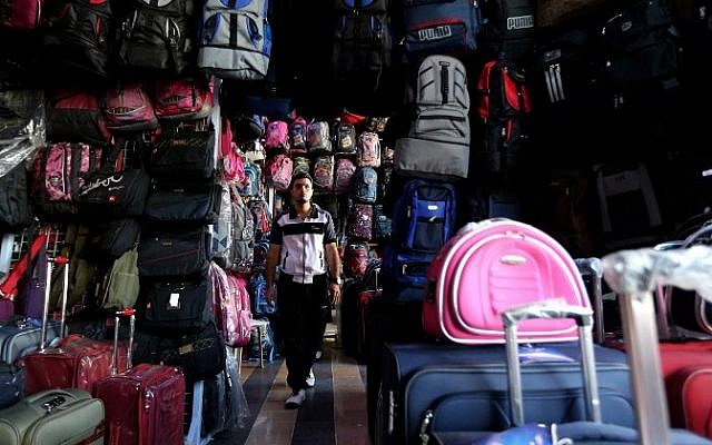 A Syrian man looks at backpacks and suitcases for sale at a market in Damascus on September 22, 2015. When customers ask which of the backpacks displayed in the Souk al-Khija market is the sturdiest, the shopkeeper knows they are planning to take to the sea to reach Germany. (AFP/LOUAI BESHARA) A Syrian man looks at backpacks and suitcases for sale at a market in Damascus on September 22, 2015. When customers ask which of the backpacks displayed in the Souk al-Khija market is the sturdiest, the shopkeeper knows they are planning to take to the sea to reach Germany. (AFP/LOUAI BESHARA)