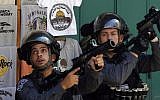 Israeli security forces raise their weapons as Palestinians throw stones from inside the al-Aqsa mosque compound during clashes on the Temple Mount in Jerusalem on September 28, 2015. (AFP PHOTO/AHMAD GHARABLI)