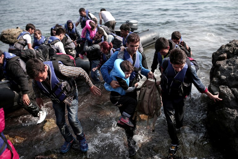 Syrian refugees land on the shores of the Greek island of Lesbos in an inflatable dingy across the Aegean Sea from Turkey, September 3, 2015. (AFP/Angelos Tzortzinis) Syrian refugees land on the shores of the Greek island of Lesbos in an inflatable dingy across the Aegean Sea from Turkey, September 3, 2015. (AFP/Angelos Tzortzinis)