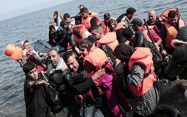 Syrian refugees land on the shores of the Greek island of Lesbos in an inflatable dingy across the Aegean Sea from Turkey on September 3, 2015. (AFP/Angelos Tzortzinis) Syrian refugees land on the shores of the Greek island of Lesbos in an inflatable dingy across the Aegean Sea from Turkey on September 3, 2015. (AFP/Angelos Tzortzinis)