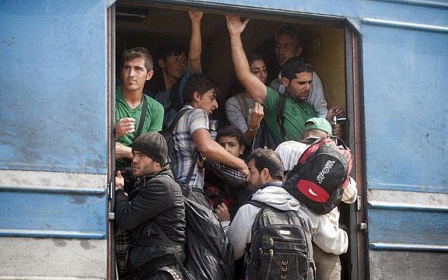 Migrants and refugees board a train after crossing the Macedonian-Greek border near Gevgelija on September 7, 2015.  (AFP PHOTO / ROBERT ATANASOVSKI)