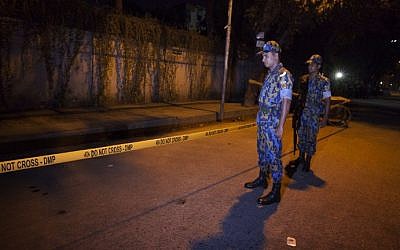 Bangladeshi police officers stand guard on September 28, 2015 at the site where an Italian charity worker has died after being shot by attackers in Dhaka. (AFP)