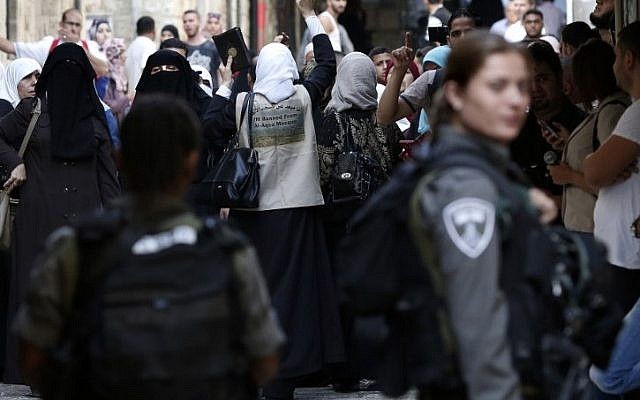 Palestinians shout slogans in front of Israeli security forces who block a street leading to the Temple Mount, in the Muslim Quarter of Jerusalem's Old City, on September 15, 2015. (AFP/Thomas Coex) Palestinians shout slogans in front of Israeli security forces who block a street leading to the Temple Mount, in the Muslim Quarter of Jerusalem's Old City, on September 15, 2015. (AFP/Thomas Coex)