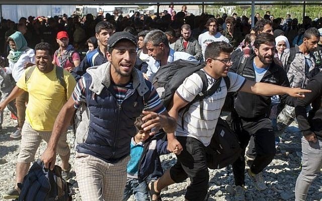Migrants and refugees run to board a train after crossing the Macedonia-Greek border near Gevgelija on September 13, 2015. (Robert Atanasovski/AFP) Migrants and refugees run to board a train after crossing the Macedonia-Greek border near Gevgelija on September 13, 2015. (Robert Atanasovski/AFP)