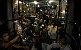 Migrant people sleep on a bus as they are transported from Budapest to the Hungarian village of Hegyeshalom, on the border with Austria, early on September 5, 2015. (AFP PHOTO/ PETER KOHALMI)