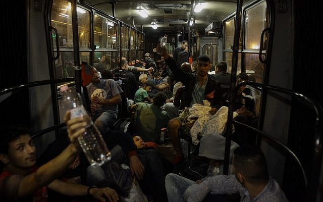 Migrant people sleep on a bus as they are transported from Budapest to the Hungarian village of Hegyeshalom, on the border with Austria, early on September 5, 2015. (AFP PHOTO/ PETER KOHALMI) Migrant people sleep on a bus as they are transported from Budapest to the Hungarian village of Hegyeshalom, on the border with Austria, early on September 5, 2015. (AFP PHOTO/ PETER KOHALMI)