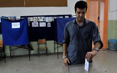 A young man casts his vote in a polling station in Thessaloniki, on September 20, 2015.  Greece's maverick leader Alexis Tsipras was fighting for a second chance to govern the struggling Eurozone nation in a tense election with rival conservatives that is proving too close to call.  (AFP/ Sakis Mitrolidis)