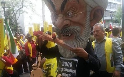 An anti-Rouhani protester dons a papier-mâché head of the Iranian president during a demonstration outside the UN building in New York, September 28, 2015. (Rebecca Shimoni Soil) 