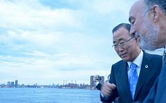 UN chief Ban Ki-moon, left, and Israeli envoy Ron Prosor casting their sins into Turtle Bay on September 21, 2015. (Gemma Manalese)