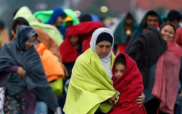 Migrants arrive at the Hungarian-Austrian border in Nickelsdorf, Austria, Saturday, Sept. 5, 2015, where they came from Budapest as Austria in the early-morning hours said it and Germany would let them in. (AP Photo/Frank Augstein)