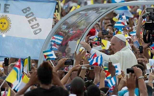 Pope Francis arrives for Mass at Revolution Plaza in Havana, Cuba, Sunday, Sept. 20, 2015, where people wave Cuban, Vatican and Argentine flags. (AP Photo/Ramon Espinosa)