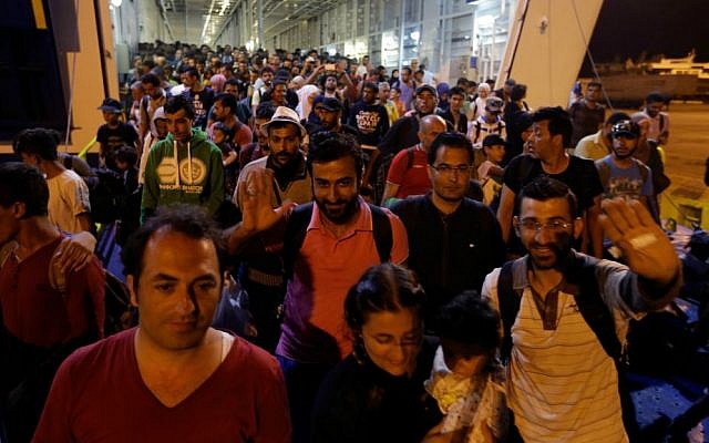 Migrants disembark from the catamaran Terra Jet at the Athens port of Piraeus, on Tuesday, Sept. 1, 2015. (AP Photo/Thanassis Stavrakis)