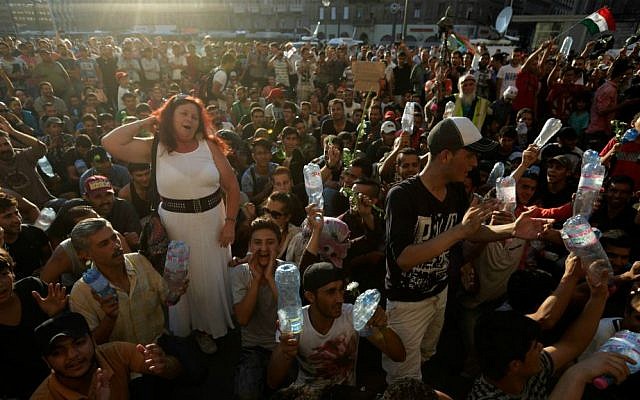 Hundreds of migrants wait in front of the Keleti Railway Station after police stopped them from boarding trains to Germany, Budapest, Hungary, Tuesday, Sept. 1, 2015. (AP Photo/Petr David Josek)