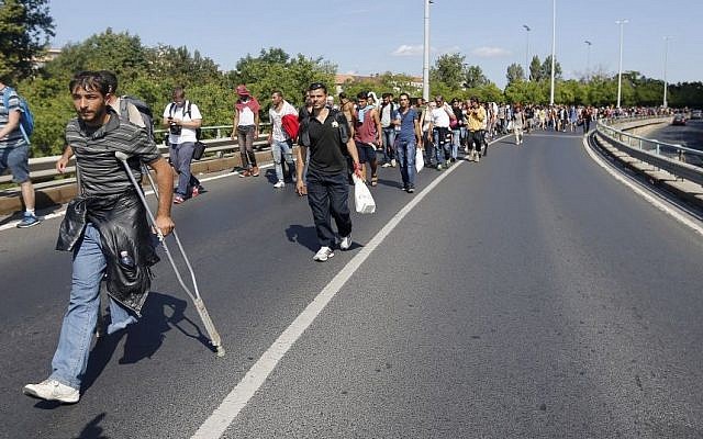 A large group of asylum-seekers walk out of Budapest, Hungary, Sept. 4, 2015. (AP/Frank Augstein)