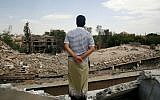 A man looks at the Houthi-controlled headquarters of the Yemeni army destroyed by Saudi-led airstrikes in Sanaa, Yemen,  September 16, 2015. (AP Photo/Hani Mohammed)