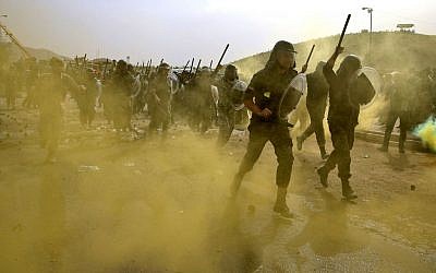A group of Iranian paramilitary Basij forces re-enact a riot situation during training in a Revolutionary Guard base in northeastern Tehran, Iran, April 24, 2015. (AP Photo/Ebrahim Noroozi)
