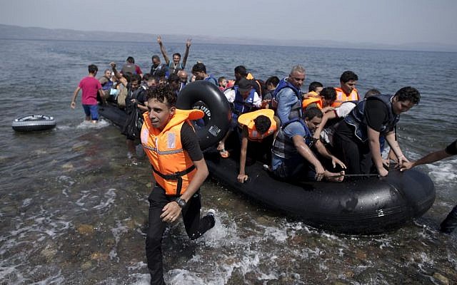 Syrians arrive on a dinghy after crossing from Turkey, at the Greek island of Lesbos, Monday, September 7, 2015. (Petros Giannakouris/AP) Syrians arrive on a dinghy after crossing from Turkey, at the Greek island of Lesbos, Monday, September 7, 2015. (Petros Giannakouris/AP)