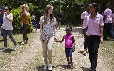Clinton Foundation Vice Chair Chelsea Clinton walks with Theresa Balde, 5, while she talks with a Chakipi Distribution Enterprise worker during a visit at the Acceso Peanut Enterprise Corporation and Chakipi Distribution Enterprise, in Mirebalais, Haiti, Wednesday, July 29, 2015. (Dieu Nalio Chery/AP) Clinton Foundation Vice Chair Chelsea Clinton walks with Theresa Balde, 5, while she talks with a Chakipi Distribution Enterprise worker during a visit at the Acceso Peanut Enterprise Corporation and Chakipi Distribution Enterprise, in Mirebalais, Haiti, Wednesday, July 29, 2015. (Dieu Nalio Chery/AP)