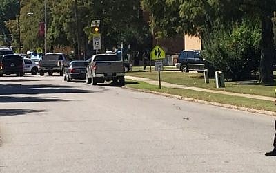 A law enforcement officer stands watch as emergency vehicles clog a road adjacent to Delta State University after an active shooter was reported in Cleveland, Miss., Monday, Sept. 14, 2015. (Courtney Warren/The Bolivar Commercial, via AP)