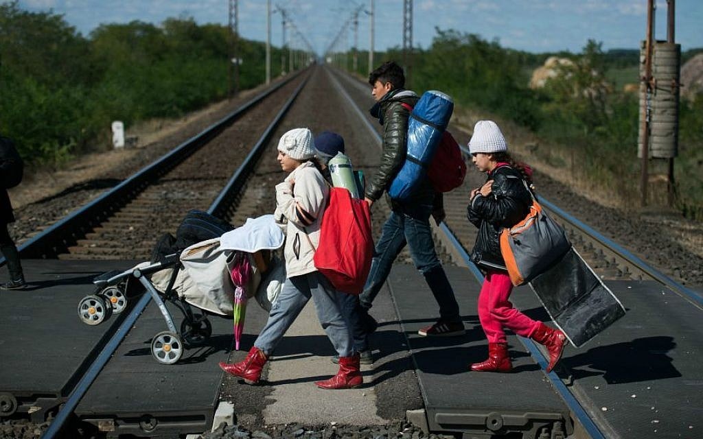 Migrants cross a railway on their way to the Austrian - Hungarian border near Hegyeshalom, Hungary, on September 28, 2015. (AP Photo/Christian Bruna)
