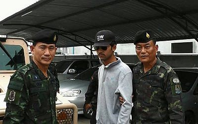 Thai police escort a suspect after he was arrested on September 1, 2015 in connection with a bomb attack in Bangkok on August 17. (Thairath/AFP) Thai police escort a suspect after he was arrested on September 1, 2015 in connection with a bomb attack in Bangkok on August 17. (Thairath/AFP)