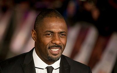 In this file photo photo dated Thursday, Dec. 5, 2013, British actor Idris Elba, who plays Nelson Mandela in the movie "Mandela: Long Walk to Freedom," poses for photographers in London. (AP Photo/Matt Dunham, File)