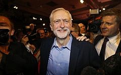Jeremy Corbyn smiles as he leaves the stage after he is announced as the new leader of the UK opposition Labour Party during the Labour Party Leadership Conference in London, Saturday, Sept. 12, 2015. (AP/Kirsty Wigglesworth)