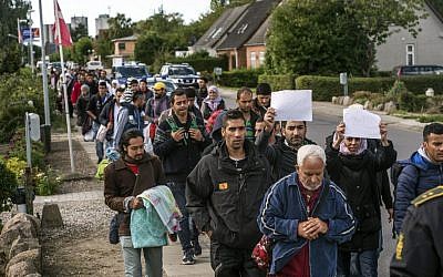 Illustrative: Middle Eastern migrants, who came from Germany by ferry and train Sunday night, and are walking from Rodby in southern Denmark towards Sweden on Monday Sept. 7, 2015. (AP/POLFOTO, Per Rasmussen)