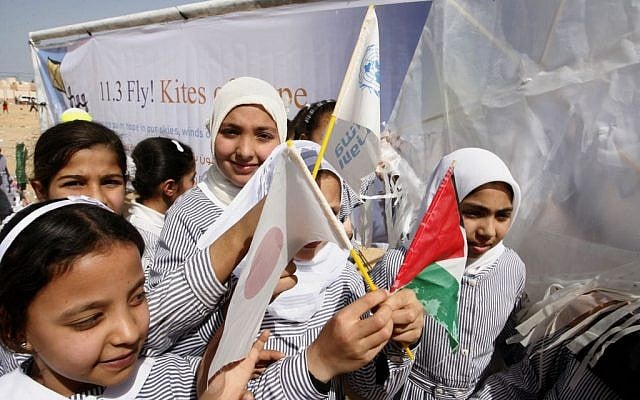 Palestinian school girls holds the flags of Palestine and the flag of Japan to show their solidarity with Japan in Khan Younis, southern Gaza Strip, March 11, 2013 (Abed Rahim Khatib/Flash90)