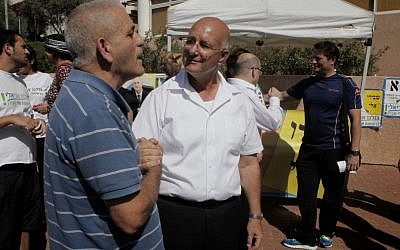Eli Shaviro (center) seen at a polling station in Ariel on October 22, 2013. (Flash90) 