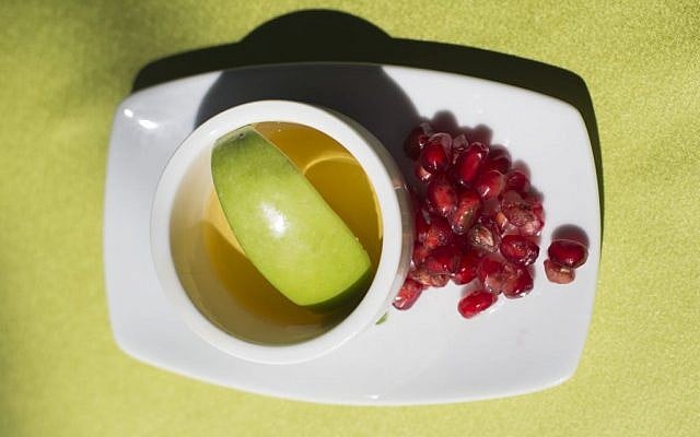 Apple in honey and pomegranate, traditionally eaten during Rosh Hashanah (Noam Revkin Fenton/ Flash90) Apple in honey and pomegranate, traditionally eaten during Rosh Hashanah (Noam Revkin Fenton/ Flash90)
