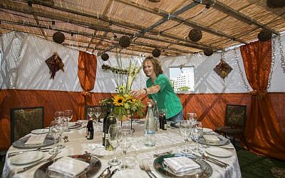 Illustrative image of a woman decorating a sukkah at the Inbal Jerusalem Hotel on October 7, 2014. (Yonatan Sindel/Flash90)