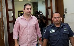 Eran Malka, left, a former top police officer caught in a corruption case, leaves the Jerusalem District Court in Jerusalem, June 15, 2015. (Yonatan Sindel/Flash90)