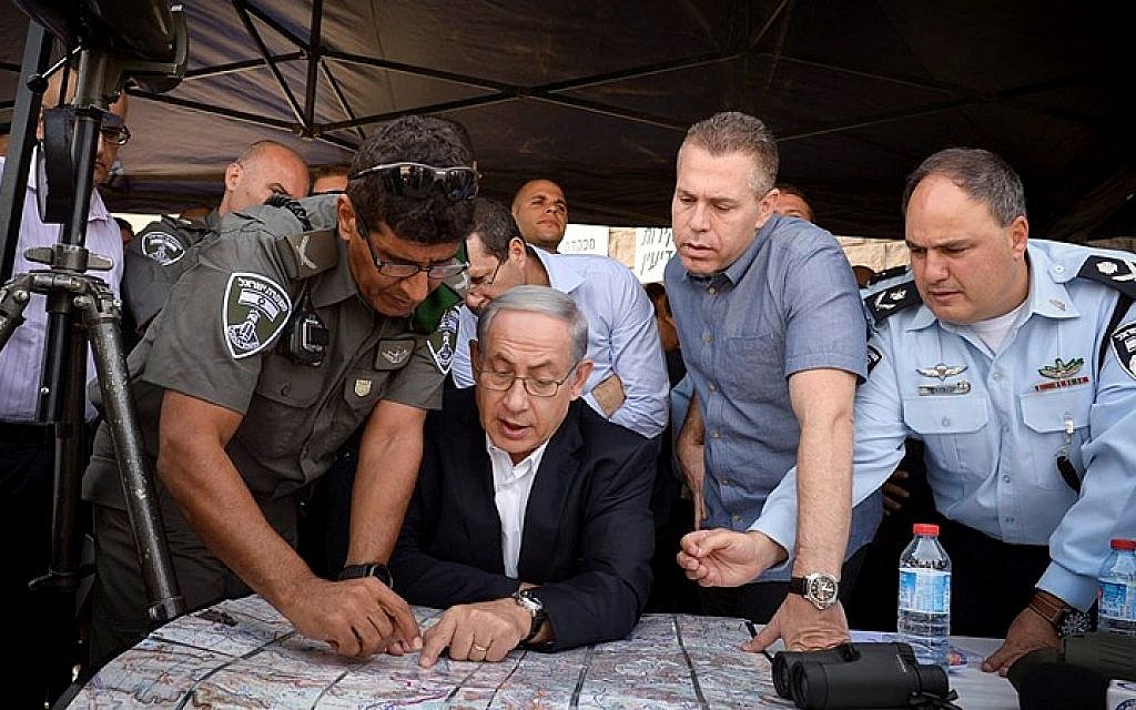 Prime Minister Benjamin Netanyahu and Minister of Public Security Gilad Erdan tour Jerusalem following the recent clashes in Jerusalem's Old City, on September 16, 2015. (Amos Ben Gershom/GPO)