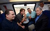 File: Prime Minister Benjamin Netanyahu, right, and Transportation Minister Yisrael Katz, left, seen with mayors of the southern Israeli towns on an Ashkelon-Beersheba train leaving from the southern Israeli city of Netivot, September 17, 2015. (Haim Zach/GPO)