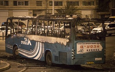 A bus set on fire, apparently by petrol bombs, at a roundabout in the East Jerusalem neighborhood of Ras al Amud, near Mount of Olives, on September 17, 2015. The bus driver took a wrong turn, entered the Palestinian neighborhood and his bus was attacked with stones. The bus was empty of passengers and the driver left it, and returned to find it on fire. (Photo by Hadas Parush/Flash90)