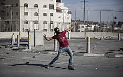 Illustrative photo of a Palestinian throwing a rock at Israeli Border Police during clashes in East Jerusalem on September 18, 2015. (Hadas Parush/Flash90/File)