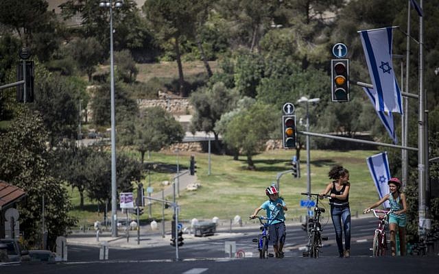 Israelis ride their bicycles along the empty streets of in central Jerusalem, on Yom Kippur, on September 23 2015. (Hadas Parush/Flash 90)